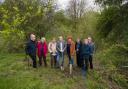 Cllr Mark Wilkes (centre), Cabinet member for neighbourhoods and climate change, and Chris Harland (right), senior investment manager at the National Lottery Heritage Fund, pictured with members of the Durham Woodland Revival project