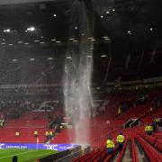 Rainwater pours through the roof of Old Trafford