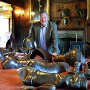 Sir Thomas with some of the armour used by the Home Guard