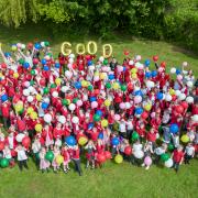 Flying high...pupils and staff from Ormesby Primary School celebrate the 'good' news