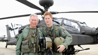 King Charles and Prince Harry in front of an Apache helicopter
