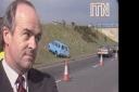 The local councillor rolls his eyes as a three car pile-up happens moments after telling a news team how safe the road was (Image: ITN Archive).