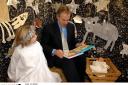 Prime Minister Tony Blair with angel Katie Bennet, narrates the `Greatest story ever told` as he joins the cast of the Nativity play during his visit to the Wingate SureStart Children's Centre, in his County Durham constituency in 2006