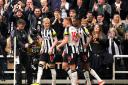 Anthony Gordon celebrates with Newcastle teammates against Tottenham