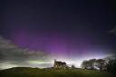 The aurora borealis, more commonly known as the Northern Lights, lit up the sky just before midnight on Tuesday (April 16) over St Aidan's church in Thockrington, Northumberland