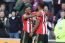 STRIKE PARTNERS: Jermain Defoe celebrates with Victor Anichebe after scoring his 150th Premier League goal in Sunderland's 3-0 win over Hull