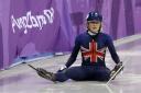 Elise Christie of Britain sits on the ice after crashing during the ladies' 500 meters short track speedskating final in the Gangneung Ice Arena at the 2018 Winter Olympics in Gangneung, South Korea, Tuesday, Feb. 13, 2018. (AP Photo/David J. Phillip)