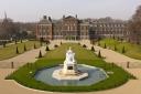 Kensington Palace is watched over by a statue of Queen Victoria