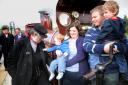 ONE IN A MILLION: The Lancaster family, from right, Ben, in father Stephen’s arms, mother April holding ten-month old Sam, who is admiring the badge of engine driver Alan Middleton
