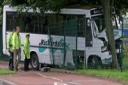 CRASH SCENE: Emergency staff inspect the school bus outside English Martyrs School on July 11, last year  