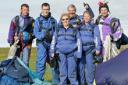 MISSION ACCOMPLISHED: Christine Wilson, centre,    with daughter Julie and Ian Cowley after their   charity parachute jumps in memory of  Andrew Wilson. Also pictured are instructors   Dave Taylor, left, Dick Kalinski, centre, and  Mal Richards, right   