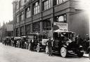 Vehicles outside The Northern Echo office dressed up for a Nig Nog Club fundraiser in the 1930s