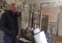 Ian Dawson in the piano room of his Reeth home which was wrecked by the flash floods