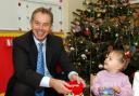 Tony Blair plays with Tia Hayton Smith, two, at the Easterside Sure Start scheme