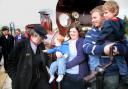 ONE IN A MILLION: The Lancaster family, from right, Ben, in father Stephen’s arms, mother April holding ten-month old Sam, who is admiring the badge of engine driver Alan Middleton