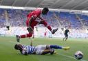 Isaiah Jones hurdles over Tom Ince during Middlesbrough's defeat at Reading