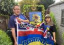 Oksana Syzemko and husband Nigel Scott with the signed flag they plan to take to soldiers on the frontline of the fighting in Ukraine: Picture Peter Barron