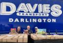 Peter Phillips, centre, with transport boss Jonathan Davies and Rotarian Jeff Mann before the latest consignment of books leaves Darlington