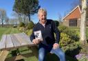 Alan Cowie with his book in aid of Macmillan Cancer Support