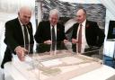 Business Secretary, Vince Cable, and Transport Secretary, Patrick McLoughlin and Alistair Dormer, Hitachi Rail Europe's executive chairman and chief executive, look at a model of the plant