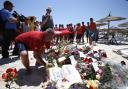 A man places a wreath of flowers during a gathering at the scene of the attack in Sousse, Tunisia
