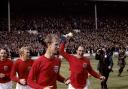 TRIUMPH: Ray Wilson, holding the trophy, celebrates with George Cohen, Bobby Moore and Jack Charlton Picture: PA