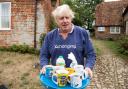 FURORE: Boris Johnson brings tea for the press to drink outside his house in Thame Picture: AARON CHOWN/PA