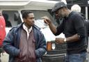 Undated film still handout from Yardie. Pictured: Aml Ameen as D and director Idris Elba on set. See PA Feature SHOWBIZ Film Elba. Picture credit should read: PA Photo/StudioCanal. All Rights Reserved. WARNING: This picture must only be