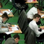 Embargoed to 0001 Tuesday July 30..Undated file photo of students sitting an exam. Poor teenagers are 18 months behind their wealthier peers in their GCSEs as progress in closing the divide has come to a standstill, according to a report. PRESS