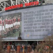 The Sir Matt Busby statue and banner outside Old Trafford in memory of the Munich air crash