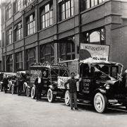 Vehicles outside The Northern Echo office dressed up for a Nig Nog Club fundraiser in the 1930s