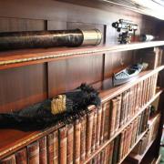 The bookshelf in the Admiral’s Study holds a myriad of mysterious looking naval equipment.