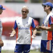Peter Moores, center, talks to Alistair Cook, right, and Joe Root at the Kensington Oval in Bridgetown, Barbados in 2015