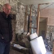 Ian Dawson in the piano room of his Reeth home which was wrecked by the flash floods