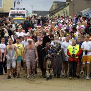 Boxing Day sea dippers march down the beach to the sea, led by a piper and the Mayor and Mayoress of the town, in 2003. Were you among the dippers on this day? Send us your photos of your experience