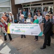 Council officials celebrate with staff and volunteers at the winning community library in Norton