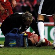 Middlesbrough young star James Morrison is treated on the pitch after being knocked unconscious following being struck in the head by a Spur boot while diving to head the ball in the box during the final minutes of the match at the Riverside