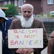 Protestors gather outside Yorkshire's ground Headingley in support of Azeem Rafiq. PICTURE: PA.