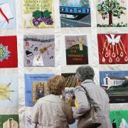 Visitors to St Mary’s admire the anniversary quilt.