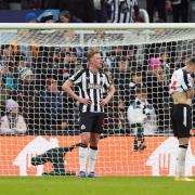 Newcastle's players show their disappointment after the 2-1 defeat to AC Milan