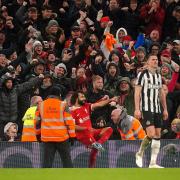 Newcastle's players show their disappointment as Mo Salah celebrates after scoring for Liverpool at Anfield