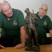 CLOSE LOOK: Richard Softley, left, and Keith Straughier view the statue