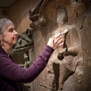 Alex Croom, curator at Arbeia Roman Fort, cleans the Regina tombstone ahead of its move to the British museum