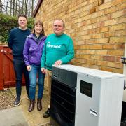 Tony Smith with the heat pump at his home, with Helen Ball and Broadacres’ sustainability apprentice Felix Orchard