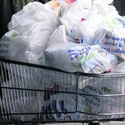 A shopper fills up on free bags before the 5p plastic bag charge was introduced this week