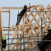 File photo dated 28/02/12 of a general view of roof workers building new houses in Derbyshire as Britain's housebuilding recovery spurred the first rise in construction output for seven months in May, raising hopes the sector's slump may be easing.  The