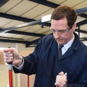 LETTER: Chancellor George Osborne uses a torque wrench to tighten a nut during a visit to an engineering company in Loughborough. A letter signed by 5,000 small firms supporting the Chancellor contains mistakes and duplicate names