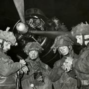 Time check: Airborne Pathfinders, who led the Paratroop drop, synchronise their watches before they set off for the invasion