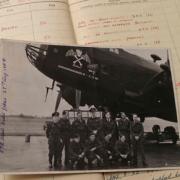 Proud role: Charlie Maddison, back row, right, with crew members and the flying log entry giving details of the D-Day mission