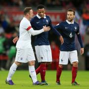 Euro star: England's Wayne Rooney (left) puts an arm around France's Anthony Martial, his Manchester United team-mate